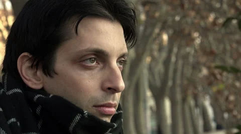 Pensive sad young man close up portrait  Stock Footage 64944069