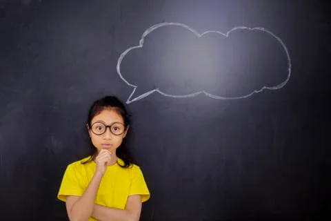Pensive schoolgirl with an empty cloud bubble Foto stock