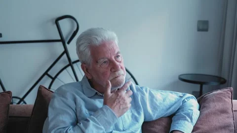Pensive senior man thinking alone at home Stock Footage 335588191