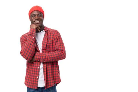 Pensive smart dark-skinned man in a casual plaid shirt is talking on a white Stock Photos