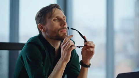 Pensive startuper thinking project taking off glasses at workplace closeup. Stock Footage 340523915
