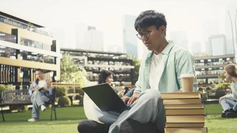 Pensive student looking at laptop learning in university campus Stock Photos
