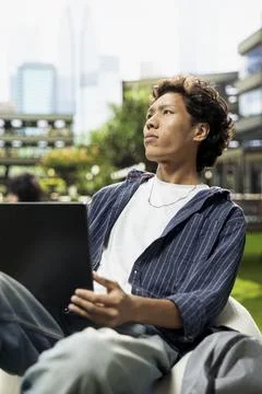 Pensive student pauses taking notes and thinking about ideas Stock Photos