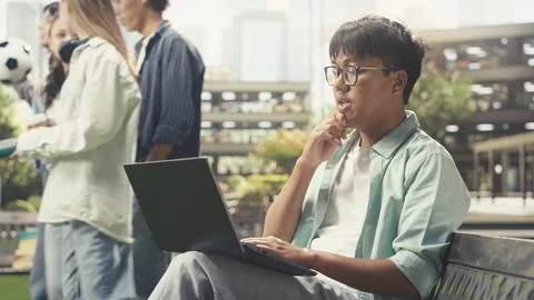 Pensive student pauses taking notes and thinking about ideas Stock Photos
