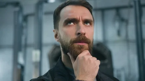 Pensive thoughtful guy Caucasian puzzled man thoughts think male auto mechanic Stock Footage 276917199