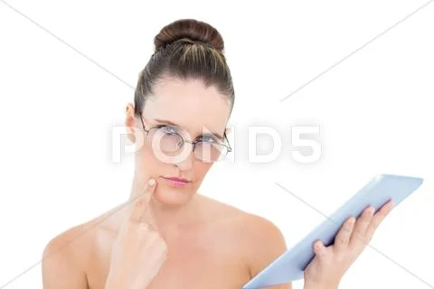 Pensive woman wearing glasses using tablet Stock Photos