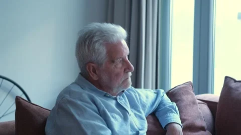 Pensive young bearded man looking out window Stock Footage 332685425