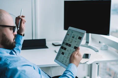 Pensive young man browsing tablet Stock Photos