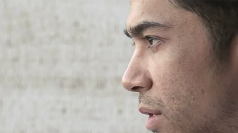 Pensive young man looking around him: side closeup portrait  Video stock 66671282