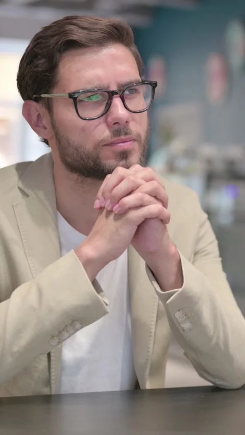 Pensive Young Man Sitting at Work Thinking, Vertical Video Video stock 342007292