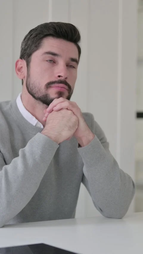 Pensive Young Man Thinking While Sitting in Office, Vertical Video Stock Footage 339582292