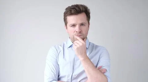 Pensive young man trying to make a right decision in complicated life situation Stock Photos