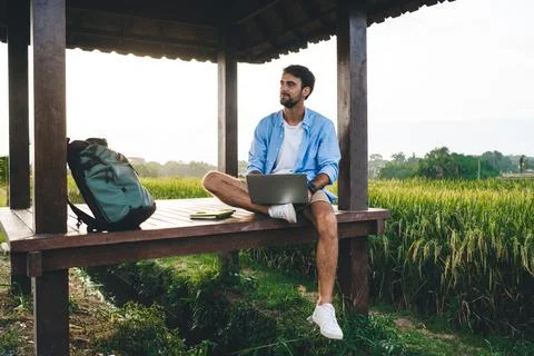 Pensive young man working on project using netbook in rural area Stock Photos