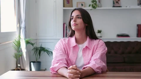 Pensive young woman thinking while sitting at home Stock Footage 335588388