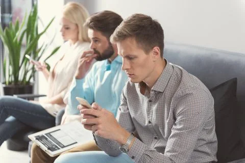 Pensive youthful candidates preparing in queue for job interview Stock Photos