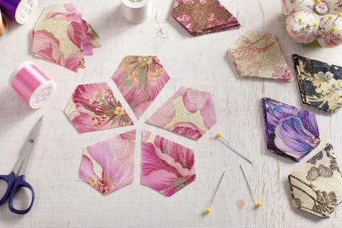 Pentagonal pieces of fabric lying in the shape of a flower Stock Photos