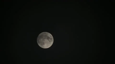 Penumbral Lunar Eclipse with Clouds Rolling over it, moments before Stock Footage 222722225