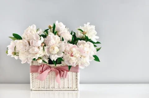 Peonies in a rustic basket, front view Stock Photos