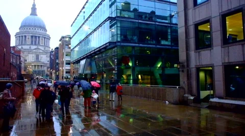 Peopl Walking with umbrellas in the rain Stock Footage 67688828