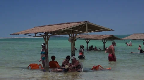People accepting sun-baths in the Dead sea Stock-Footage 39672997