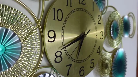 People admire a clock on a wall in a room 動画素材 341786960