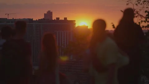 People against the backdrop of an evening sunset Stock Footage 295625553