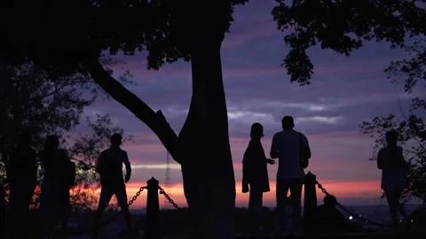 People against the backdrop of an evening sunset Stock Footage 296901734