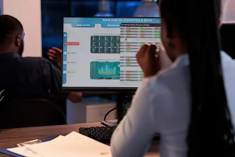 People analyzing data on large screen Stock Photos