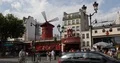 People and Car Traffic in Front of Moulin Rouge Famous Landmark Cabaret in Paris 4k or 4k+ Resolution