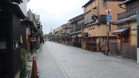 People and cars pass famous kyoto street sunday morning Stock Footage