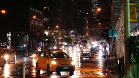 People and cars in the rain on New York Time Square at night Stock Footage