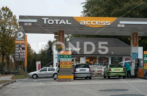 People and cars taking fuel in in Total gas Station Stock Photos
