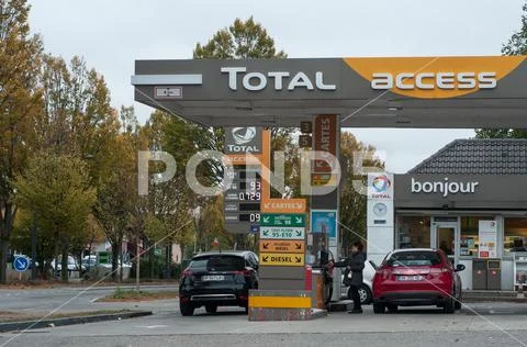People and cars taking fuel in in Total gas Station Stock Photos