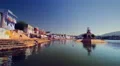 People and cows gather at the ghats of Pushkar Lake, India HD Footage