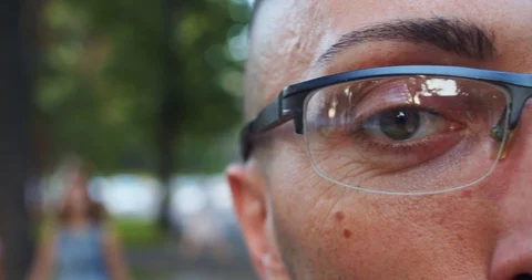 People and future technology. Close-up young man eye in glasses with innovation Video stock 116360296