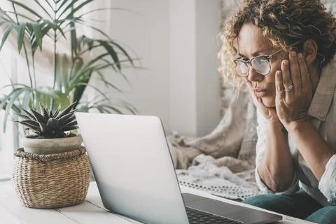 People and problems with computer concept. Woman looking laptop display with  Stock Photos