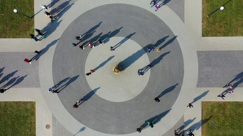 People and Shadows Moving on Circular Square, Top Down Bird Eye Cinematic Stock Footage 119376546