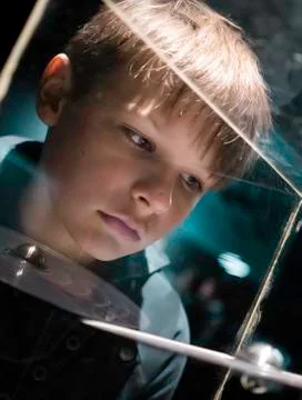 People and space. future technologies. boy looking at planetary model in a Stock Photos