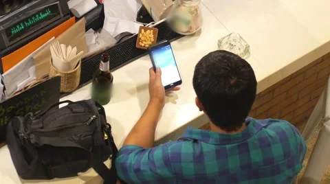 People and Technology Concept - Man with Smartphone at Bar Stockbeeldmateriaal 63613085