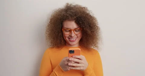 People and technology concept. Smiling positive woman with natural curly hair Stock Footage 152921804
