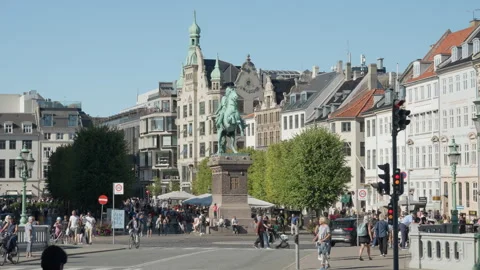 People and traffic move past the Absalon equestrian statue on Hojbro Plads Stock Footage 345589355