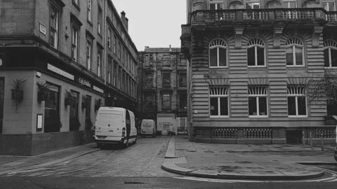People and traffic passing the camera as it focuses on the old buildings Stock Footage 171835890