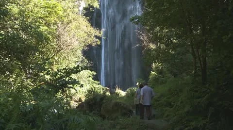 People approach a high waterfall Stock Footage 10849285
