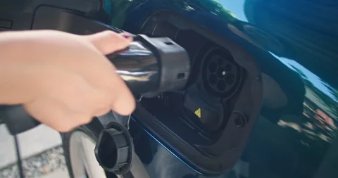 People are adding electricity to their electric cars. Stock Footage 249522103
