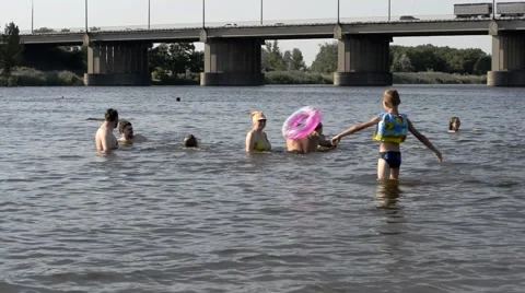 People are bathing in the river shallow. Stock Footage 65262983
