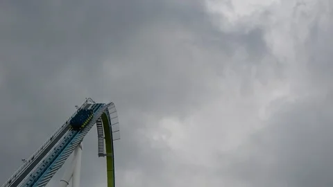 People Are Climbing Steep Roller Coaster Tracks on Cloudy Day Video stock 332381138