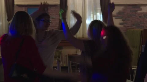 People are dancing while having a good time. Adult women dance in a restaurant Stock Footage 88866257