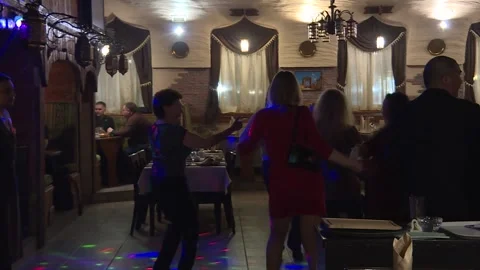 People are dancing while having a good time. Adult women dance in a restaurant Stock Footage 88866266