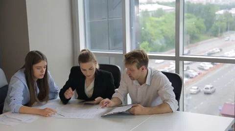 People are discussing documents pointing important parts Stock Footage 65788037