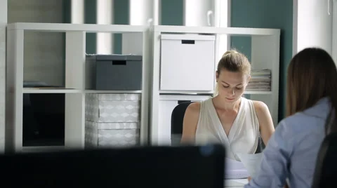 People are discussing documents sitting in office Stock Footage 65787289